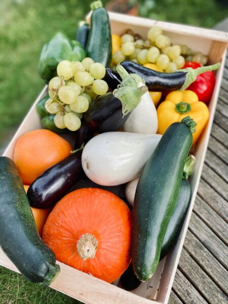a wooden crate filled with lots of different types of vegetables
