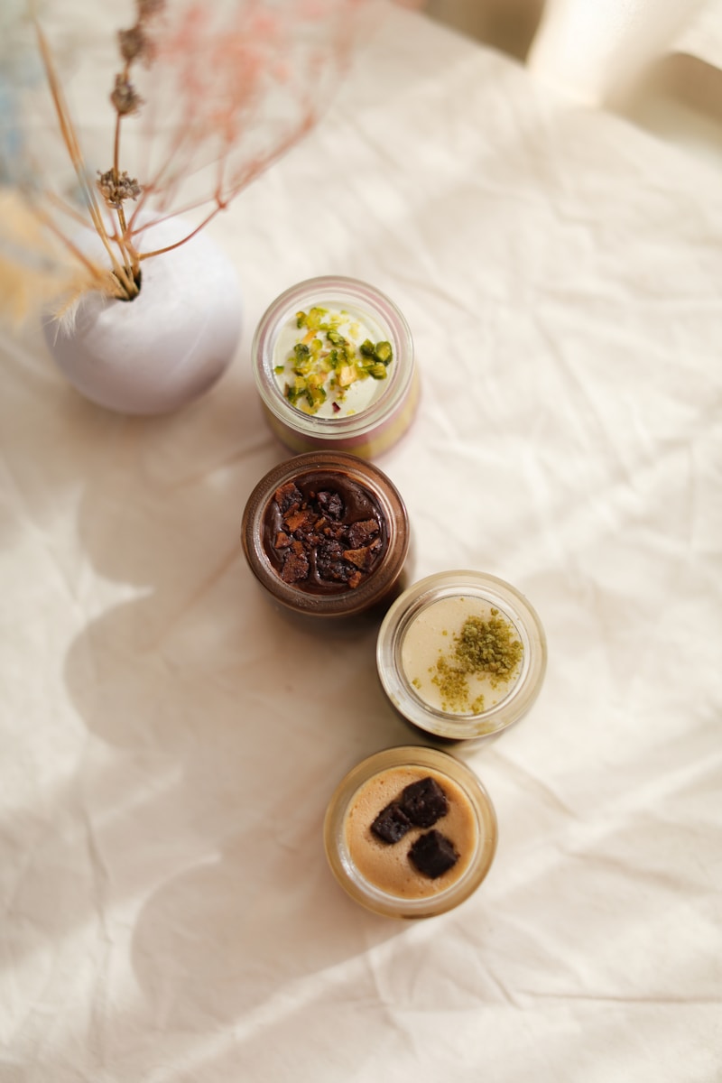 a table topped with three jars filled with food