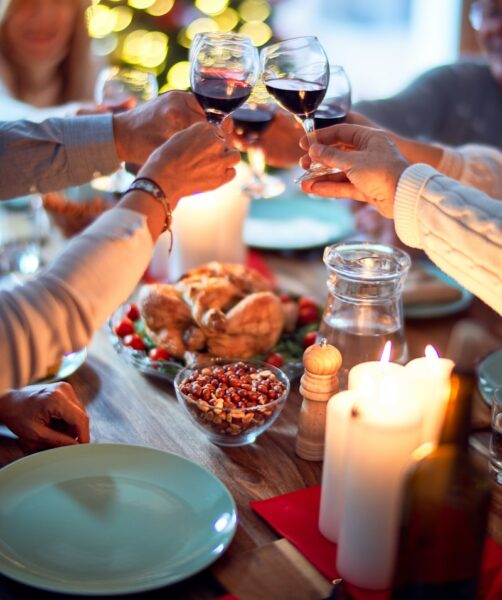 woman in white long sleeve shirt holding wine glass