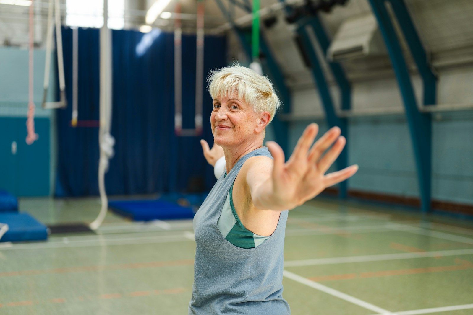 An older woman with short blonde hair in a gym.